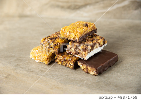 Various muesli bars on marble stone background Various muesli bars on marble stone background 48871769