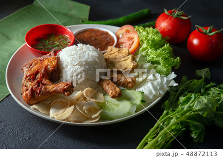 Nasi lemak kukus with fried drumstick Nasi lemak kukus with fried drumstick 48872113