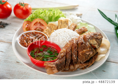Fried tilapia fish and rice 48872139