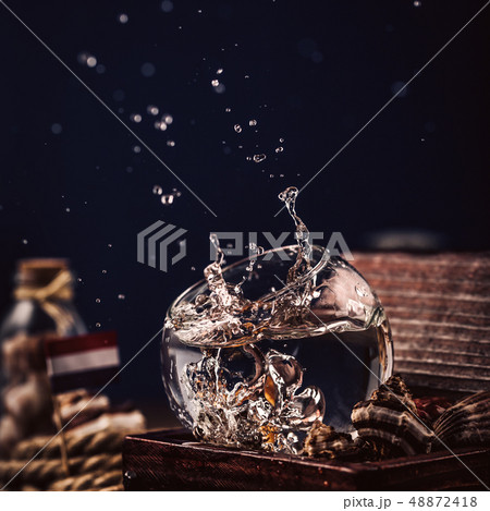 Water splash in round glass 48872418