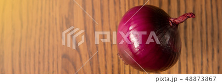 Fresh purple onion on dark wooden background. Fresh purple onion on dark wooden background. 48873867