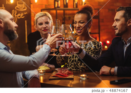 Group of friends having fun talk behind bar counter in a cafe Group of friends having fun talk behind bar counter in a cafe 48874167