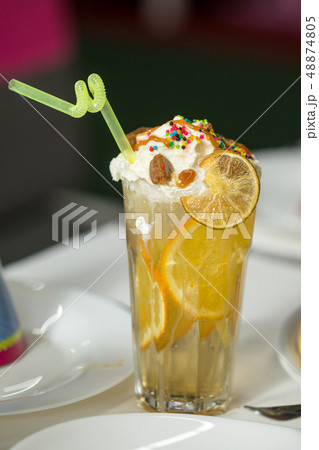 Lemonade pitcher with lemon, mint and ice on table 48874805