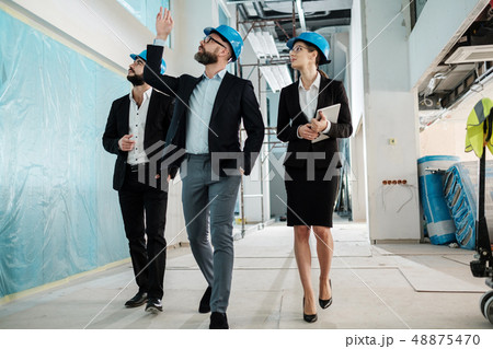 Engineers in hardhats have conversation Engineers in hardhats have conversation 48875470