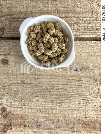dried mulberry fruits on a wooden table dried mulberry fruits on a wooden table 48876280