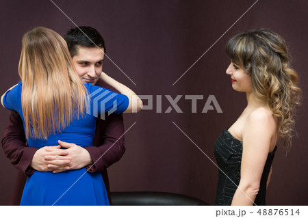 The girl is jealous of a young man to another The girl is jealous of a young man to another 48876514