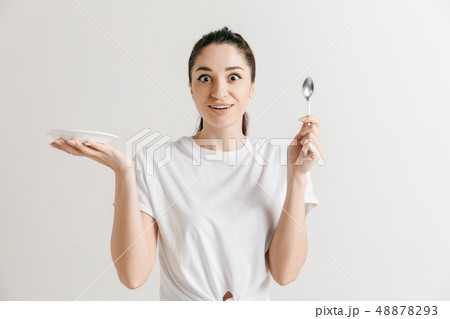 Young fun crazy brunette housewife with spoon isolated on white background Young fun crazy brunette housewife with spoon isolated on white background 48878293