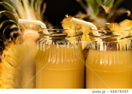 Pineapple juice and slice placed on a wooden table 48878495