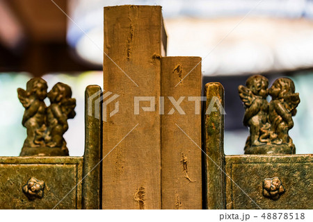 Two old books between vintage book holder with cherub figurines 48878518