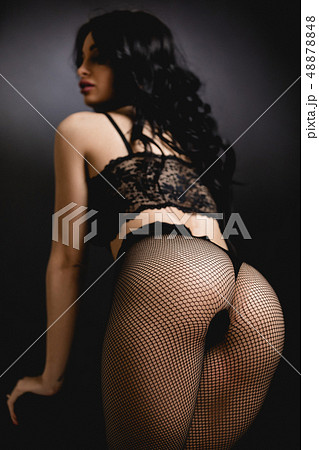 Sexy woman in lace black sensual lingerie and pantyhose with long hair posing in studio. Sexy woman in lace black sensual lingerie and pantyhose with long hair posing in studio. 48878848