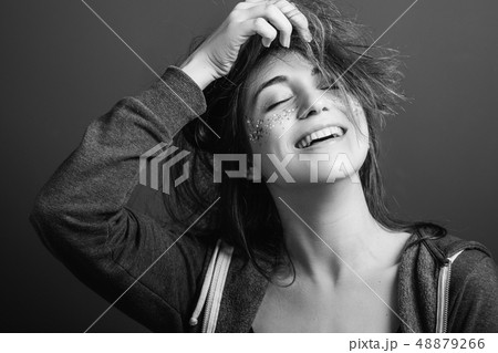 beaming young woman youth beauty playful mood 48879266