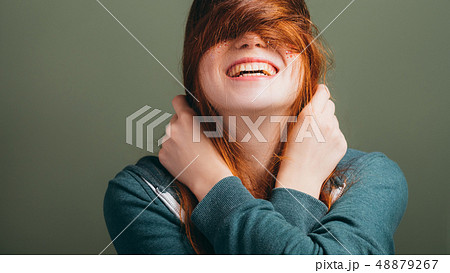female expressing joy toothy smile messing hair female expressing joy toothy smile messing hair 48879267