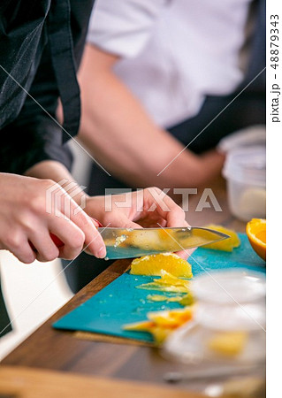 Cook cuts an orange. Master class in the kitchen. The process of cooking. Step by step. Tutorial 48879343