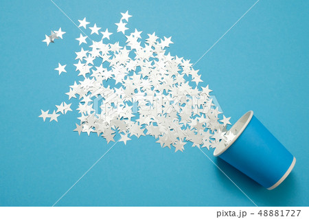 Carnival concept. Bright silver stars flying from paper cup. Carnival concept. Bright silver stars flying from paper cup. 48881727