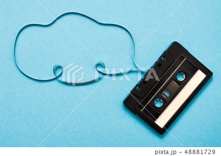 Retro music audio tape on blue baclground. Tape in cloud sign. Retro music audio tape on blue baclground. Tape in cloud sign. 48881729