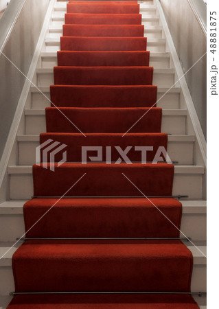 Red carpet on the stairs in a luxury interior 48881875