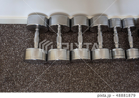 Dumbells on the floor in fitness room, 48881879