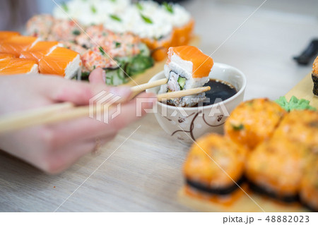 girl eating sushi set with chopsticks on restaurant 48882023