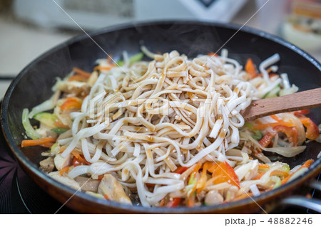Japanese ramen soup with chicken, egg, chives and sprout on dark wooden background. Japanese ramen soup with chicken, egg, chives and sprout on dark wooden background. 48882246