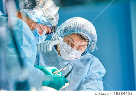 Portrait of a surgeon close-up. Surgeons operate on a patient. Tense, serious faces. Real operation 48884452
