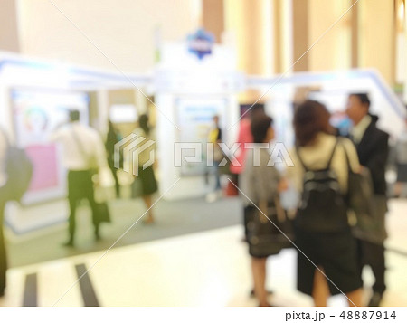 blurred image of people walking on a trade fair  blurred image of people walking on a trade fair  48887914
