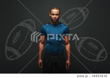 Be an inspiration. Handsome sportsman standing over dark background. Graphic drawing 48893630