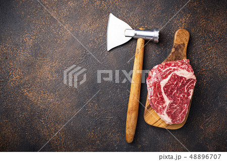 Raw marbled ribeye steak and butchers knife 48896707