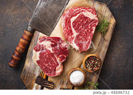 Raw marbled ribeye steak and butchers knife 48896732