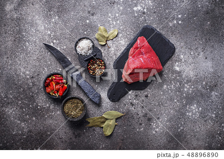 Raw meat on cutting board with spices 48896890