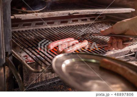 food, delicious and meat dishes concept - Horse sausages prepared on barbeque 48897806