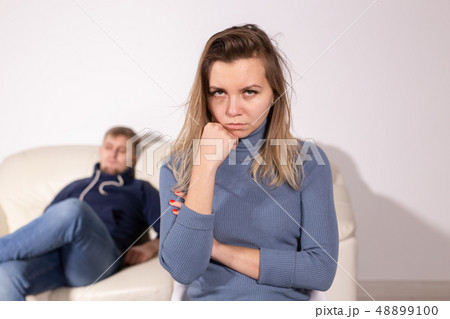 domestic violence, abuse and family concept - crying woman and her husband on the background 48899100