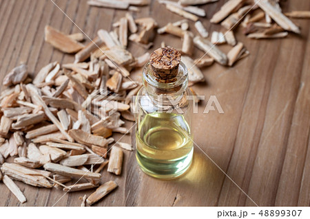 A bottle of cedar essential oil with cedar wood 48899307