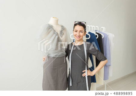 Dressmaker, fashion designer, tailor and people concept - Beautiful fashion woman designer standing 48899895