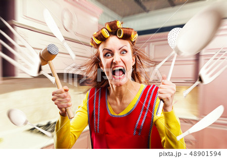 Crazy housewife in apron cooking, cookware flying Crazy housewife in apron cooking, cookware flying 48901594