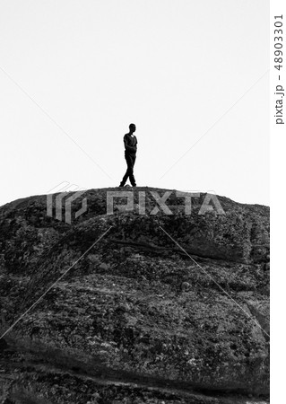 Man silhouette on rock at Meteora monastery Man silhouette on rock at Meteora monastery 48903301