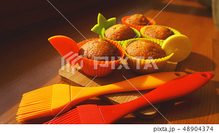 Simple mini muffins in colorful silicone bakeware. Kitchen and cooking concept Simple mini muffins in colorful silicone bakeware. Kitchen and cooking concept 48904374