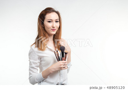 Makeup artist, beauty and cosmetics concept - Korean female make-up artist with makeup brushes on 48905120