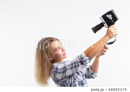 Technology, photography and people concept - Pretty young woman in plaid shirt taking a selfie over 48905174