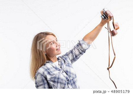 Technologies, photographing and people concept - blonde young woman with retro camera smiling over Technologies, photographing and people concept - blonde young woman with retro camera smiling over 48905179