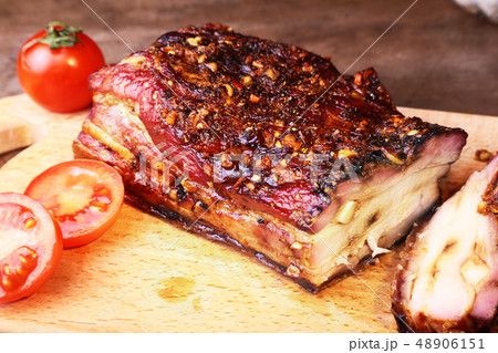 Sliced grilled pork ribs barbecue Striploin steak with chimichurri sauce and tomatoes on cutting 48906151