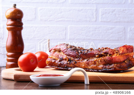 Sliced grilled pork ribs barbecue Striploin steak with chimichurri sauce and tomatoes on cutting Sliced grilled pork ribs barbecue Striploin steak with chimichurri sauce and tomatoes on cutting 48906166