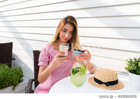 Beautiful girl hands plastic credit card, smartphone. Online application online banking, pay for 48906809