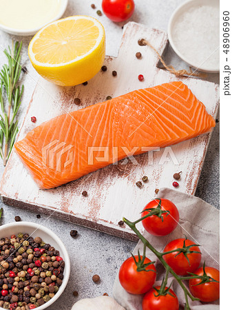 Fresh raw salmon slice on chopping board with oil 48906960
