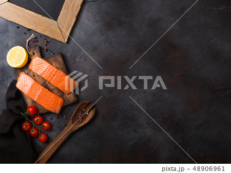 Fresh raw salmon slice on chopping board with oil Fresh raw salmon slice on chopping board with oil 48906961