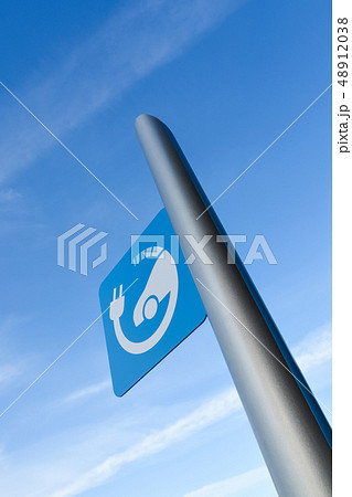 EV - electric vehicle quick charging station sign on blue sky background 48912038