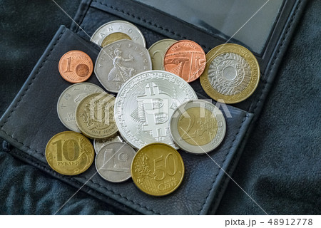 Bitcoin, national and euro coins on black leather wallet. Bitcoin, national and euro coins on black leather wallet. 48912778