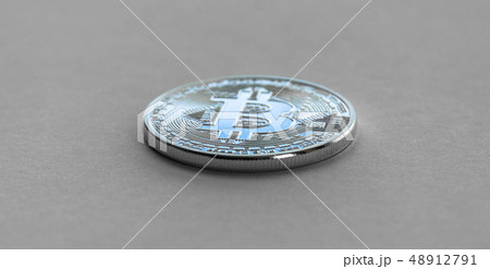 Bitcoin laying on flat surface. White metal coin. Bitcoin laying on flat surface. White metal coin. 48912791
