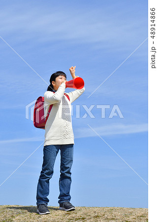 青空で応援する小学生の女の子（ランドセル、メガホン） 48914866