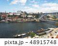 Ancient boats on Douro River. Dom Luis Bridge. 48915748