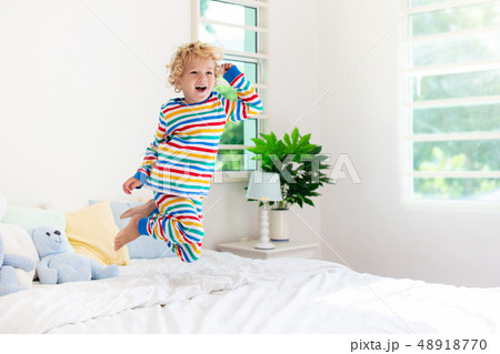 Child playing in bed. Kids room. Baby boy at home. 48918770